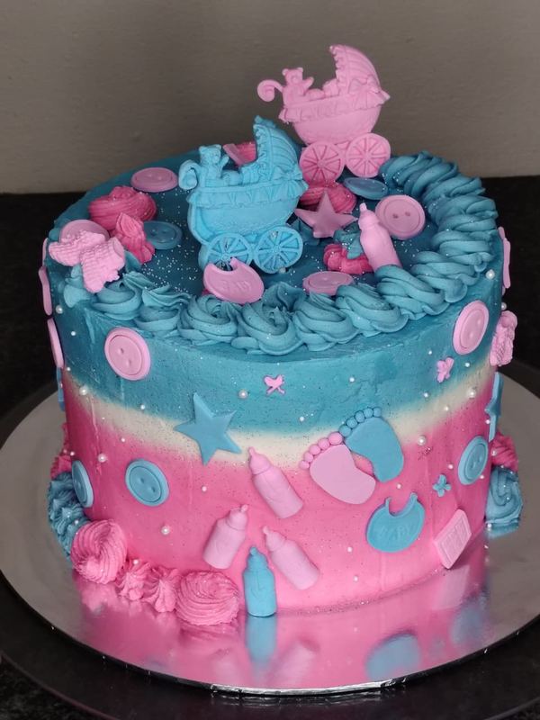 Pink and blue baby shower cake with prams, bottles and baby feet
