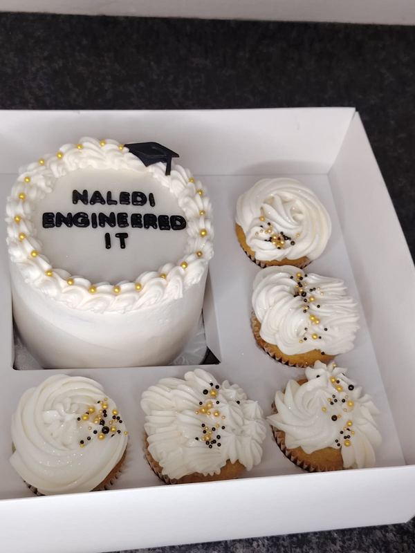 Graduation bento cake for an engineer with white and gold cupcakes in a gift box