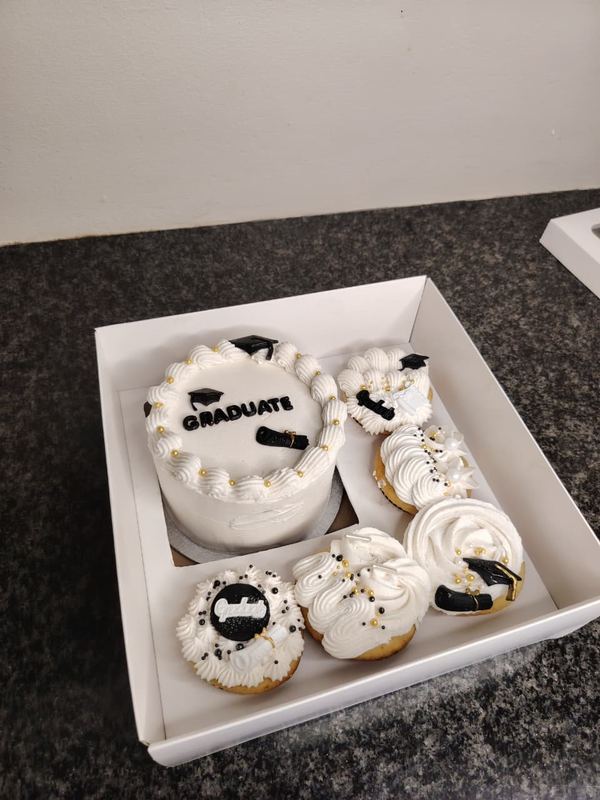 Graduate bento cake with black and white graduation cupcakes in a gift box