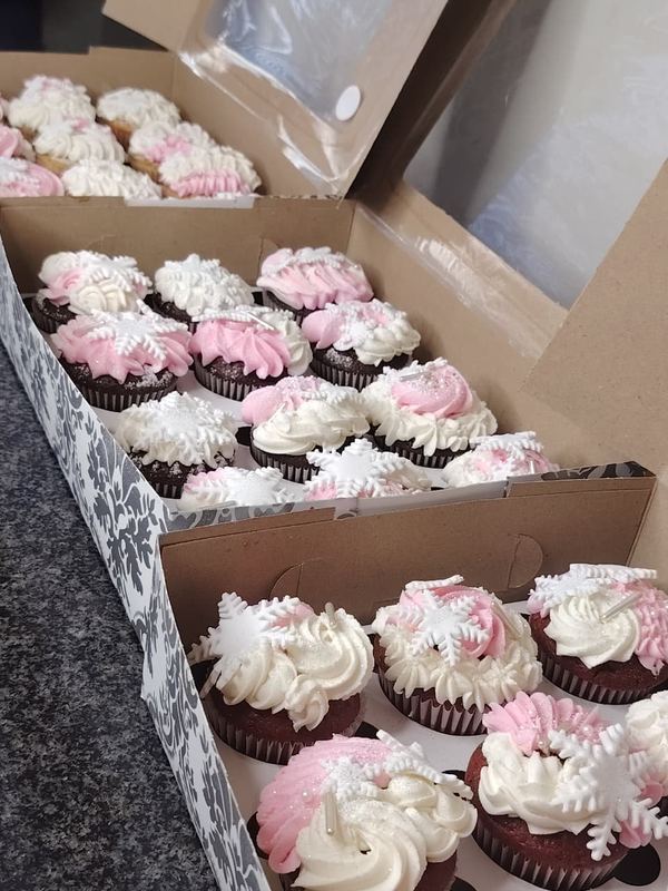 Boxes of pink and white red velvet cupcakes
