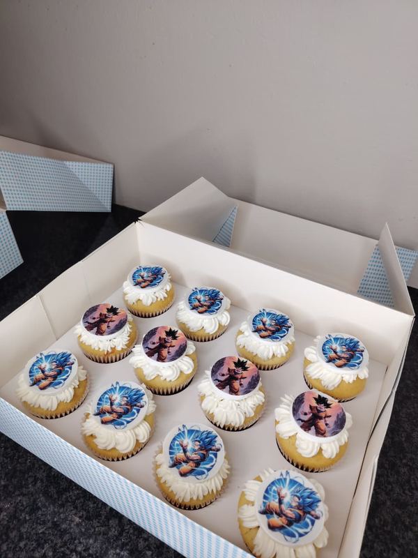 Box of cupcakes with printed character toppers