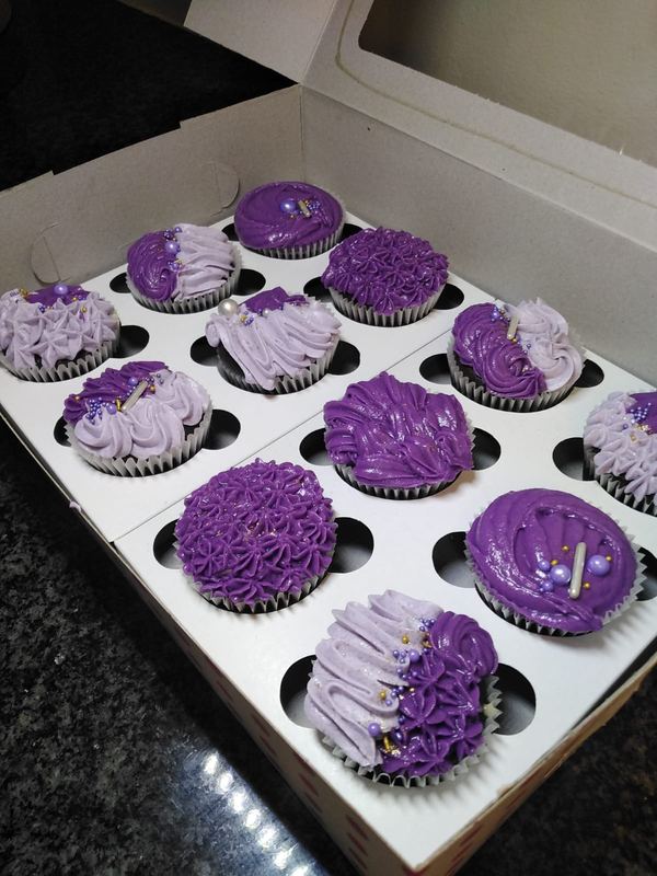Close-up of purple and lilac buttercream cupcakes