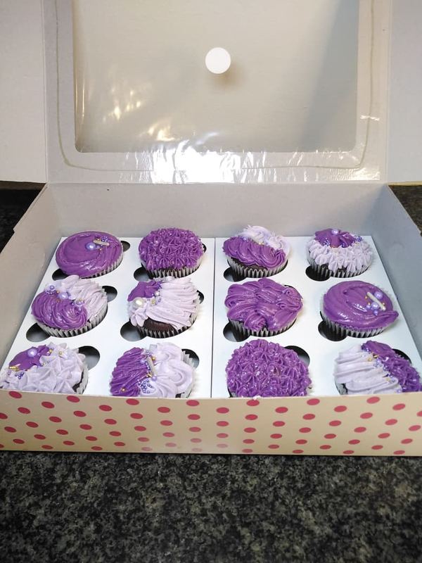 Purple and lilac cupcakes in a polka-dot box