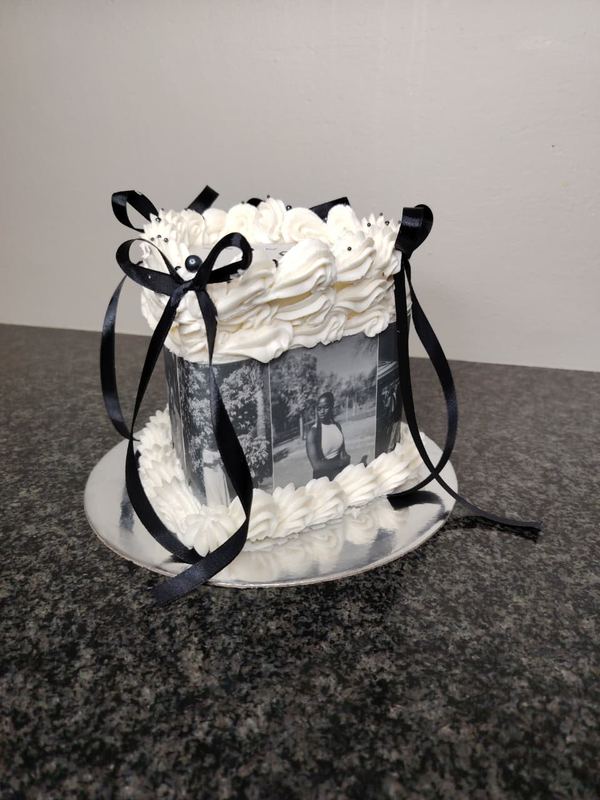 Black and white graduation photo cake with ribbon bows