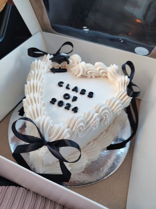 White heart Class of 2024 graduation cake with black bows