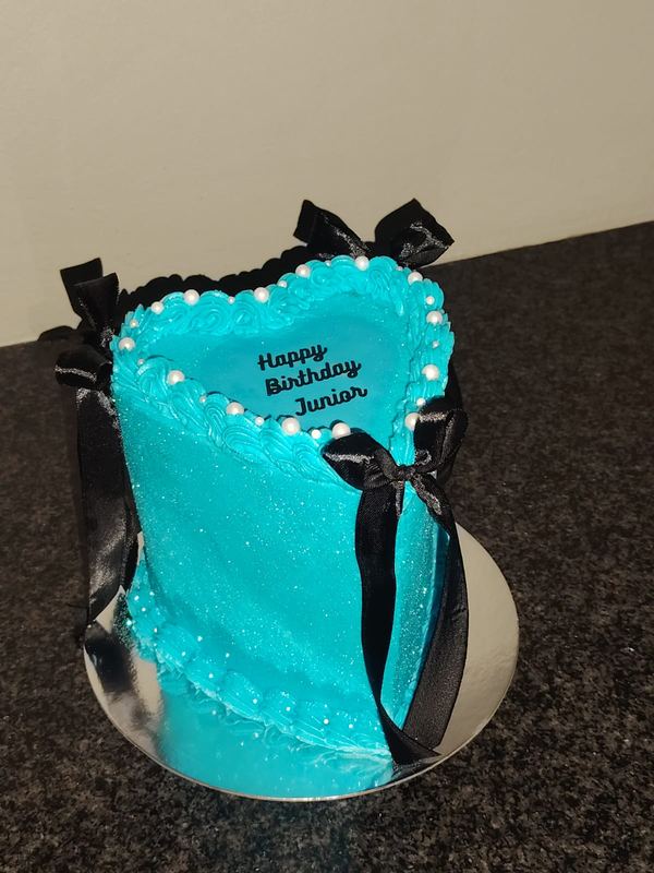 Blue shimmer heart birthday cake with pearls and black bows