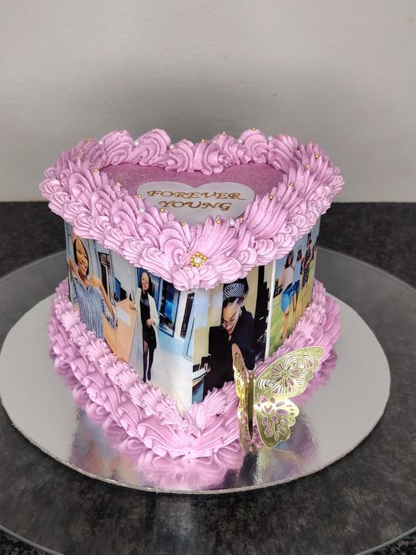 Pink heart photo cake with printed pictures and gold butterflies